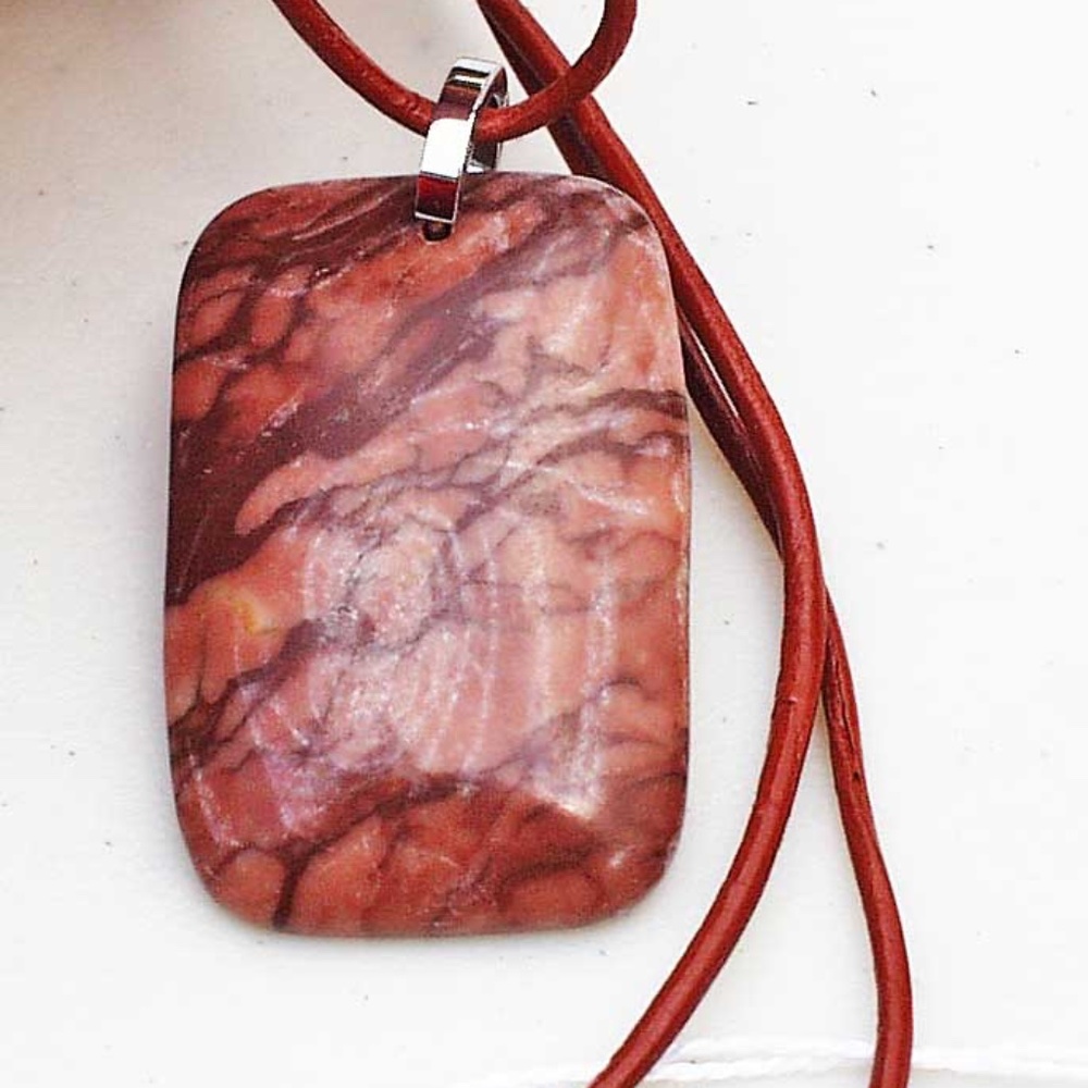 ZEBRA STONE ON LEATHER CORD, BROWNS, 26 INCHES LONG, PUFF FRONT, FLAT BACK, TAG